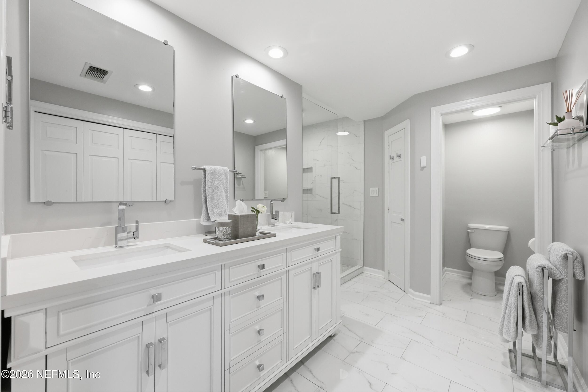 4706 Ivanhoe Road Jacksonville, FL 32210 - Photo 22 of 47 a spacious bathroom with a granite countertop sink mirror and toilet
