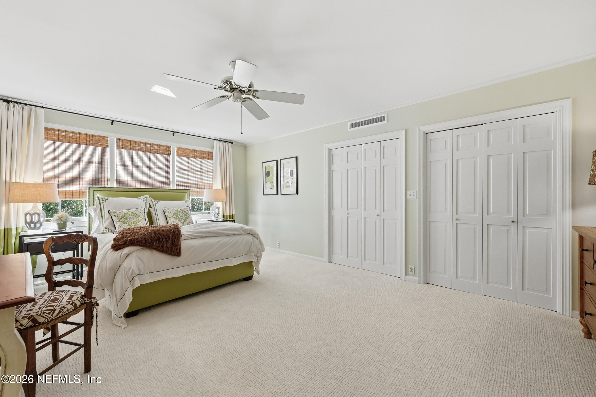 4706 Ivanhoe Road Jacksonville, FL 32210 - Photo 32 of 47 a spacious bedroom with a bed and a chandelier
