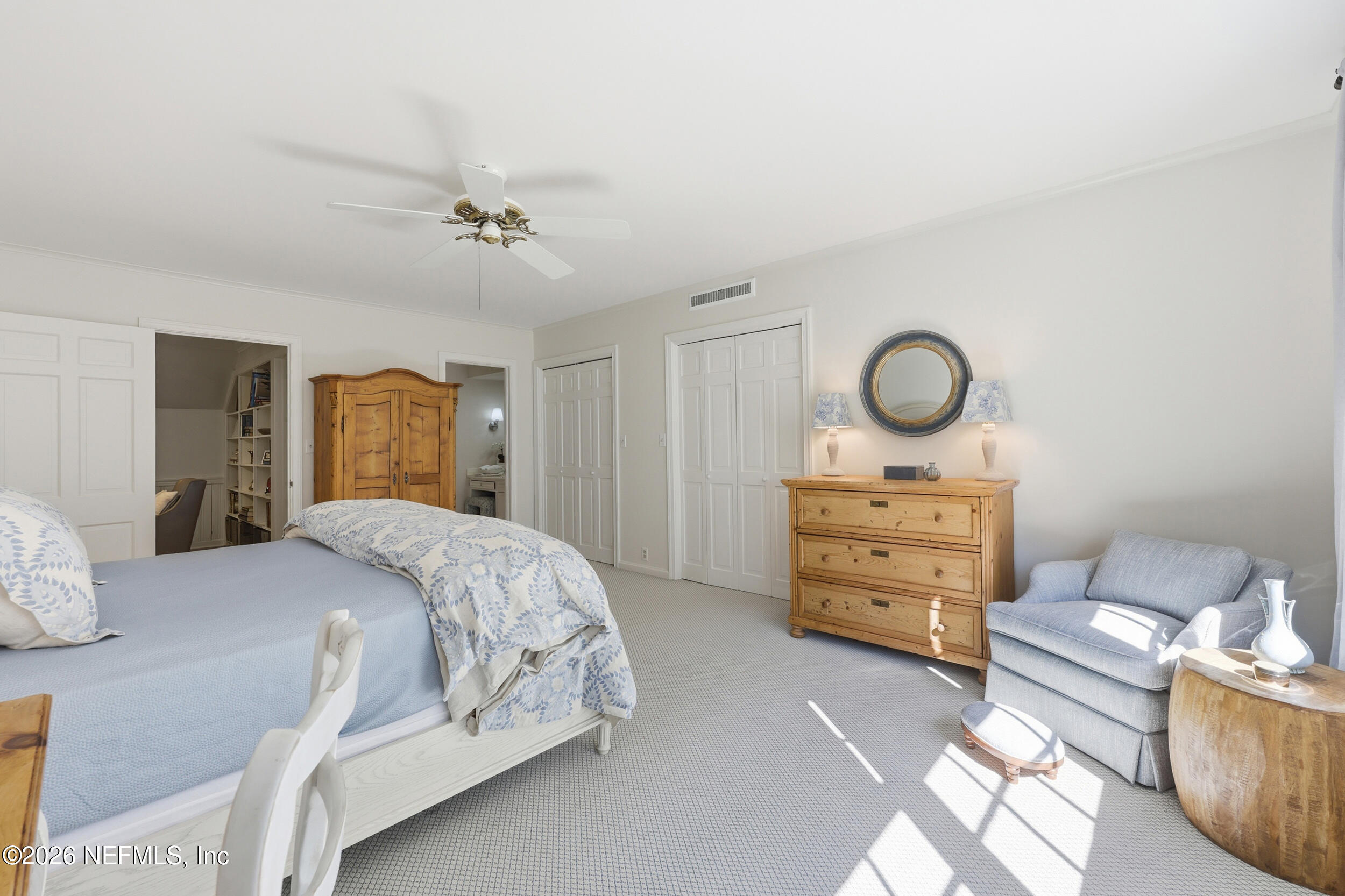 4706 Ivanhoe Road Jacksonville, FL 32210 - Photo 35 of 47 a bedroom with a bed and closet with chair