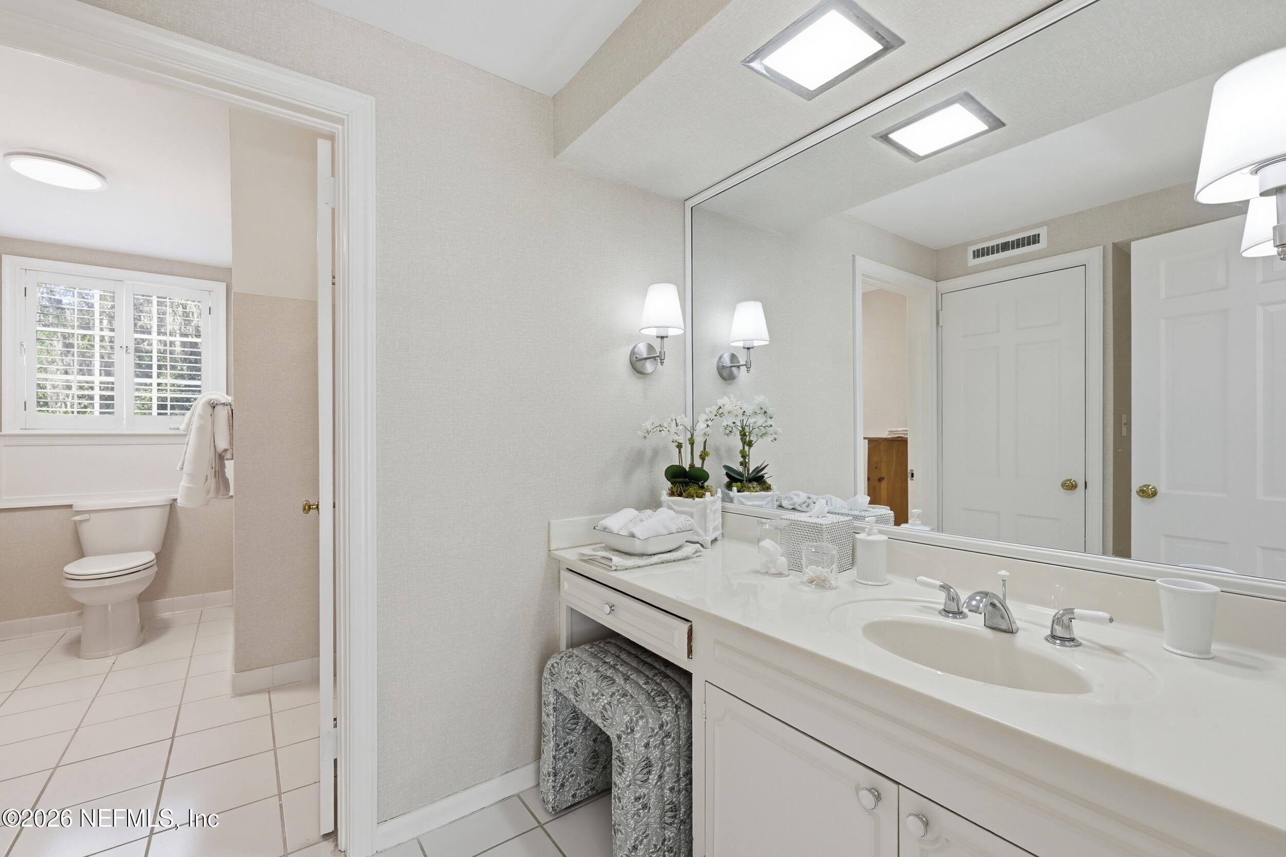 4706 Ivanhoe Road Jacksonville, FL 32210 - Photo 36 of 47 a bathroom with a sink double vanity and a toilet