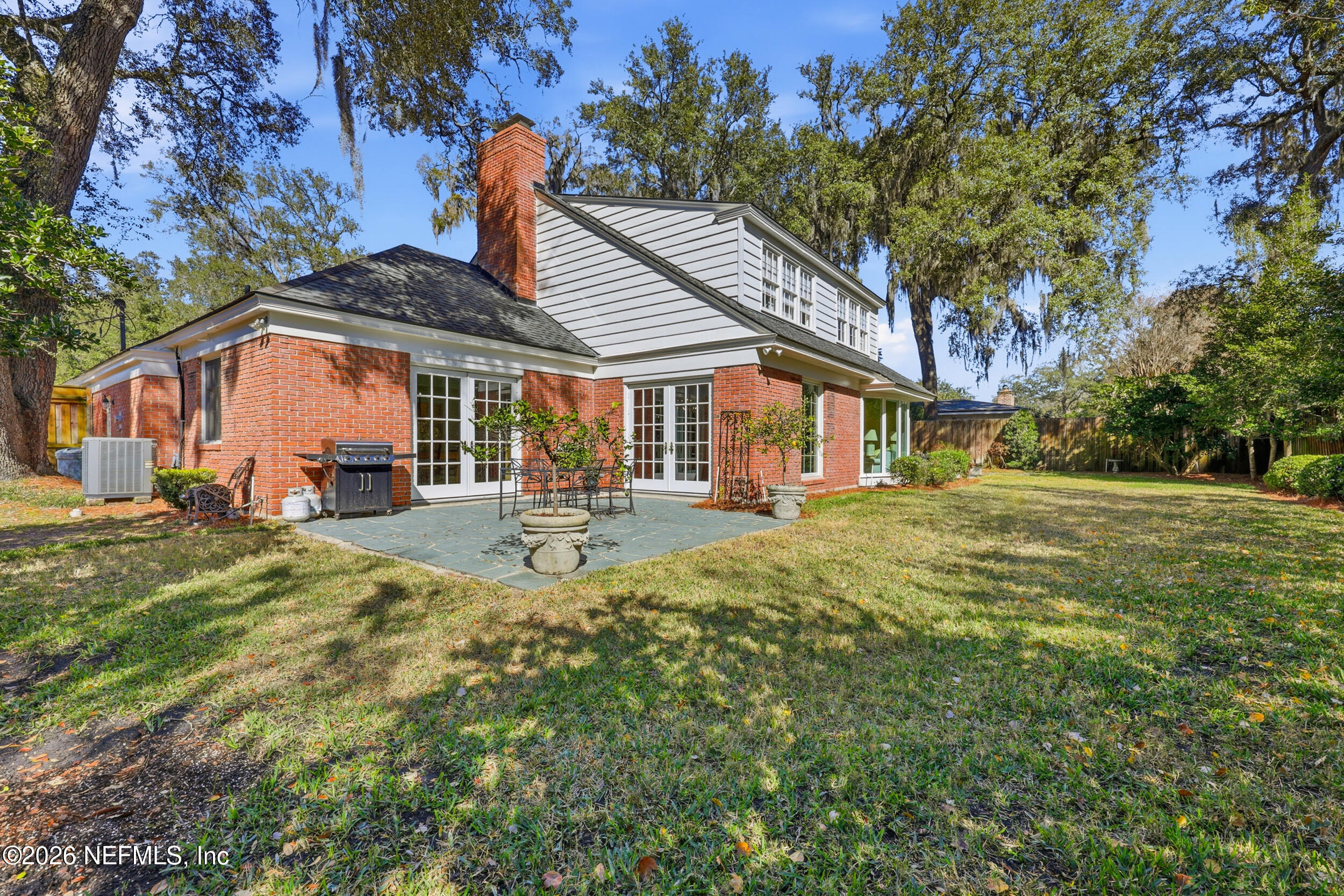 4706 Ivanhoe Road Jacksonville, FL 32210 - Photo 39 of 47 a backyard of a house with barbeque oven table and chairs