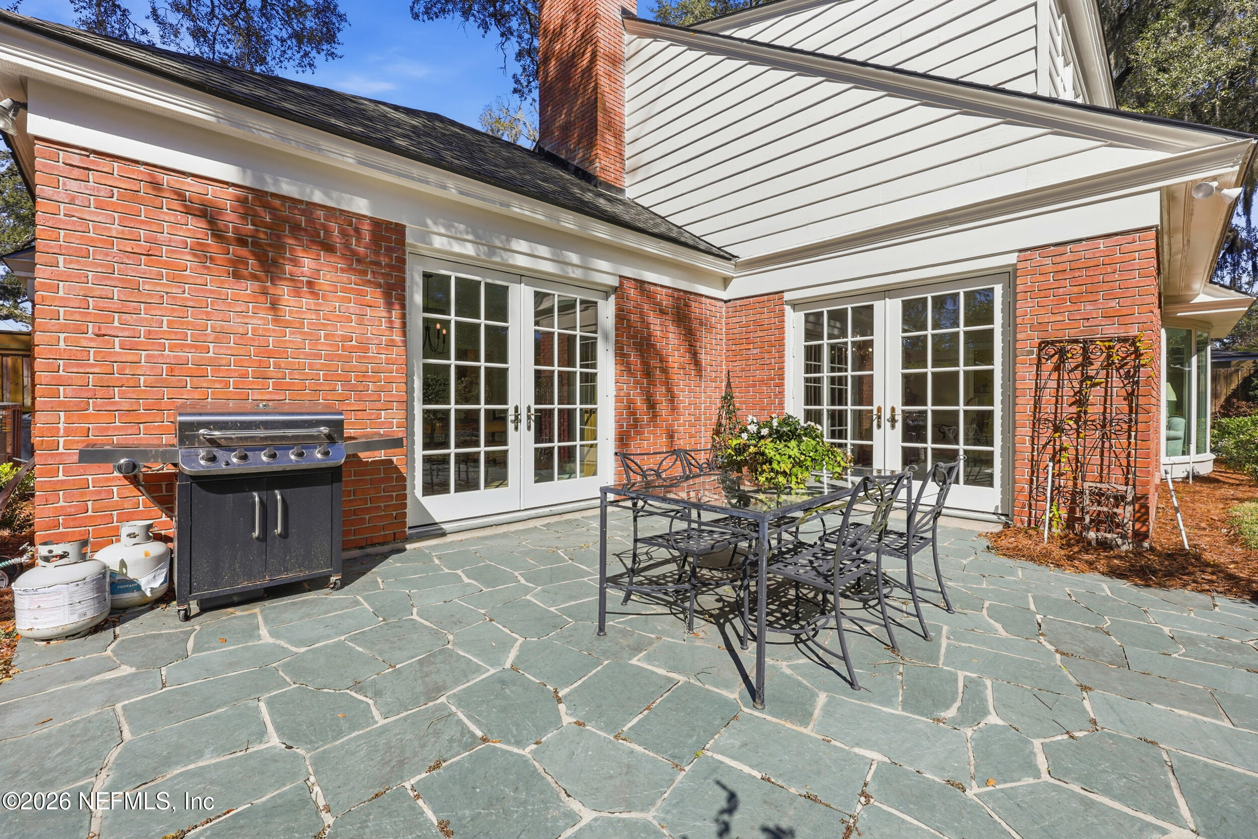 4706 Ivanhoe Road Jacksonville, FL 32210 - Photo 41 of 47 a view of a patio with table and chairs and potted plants