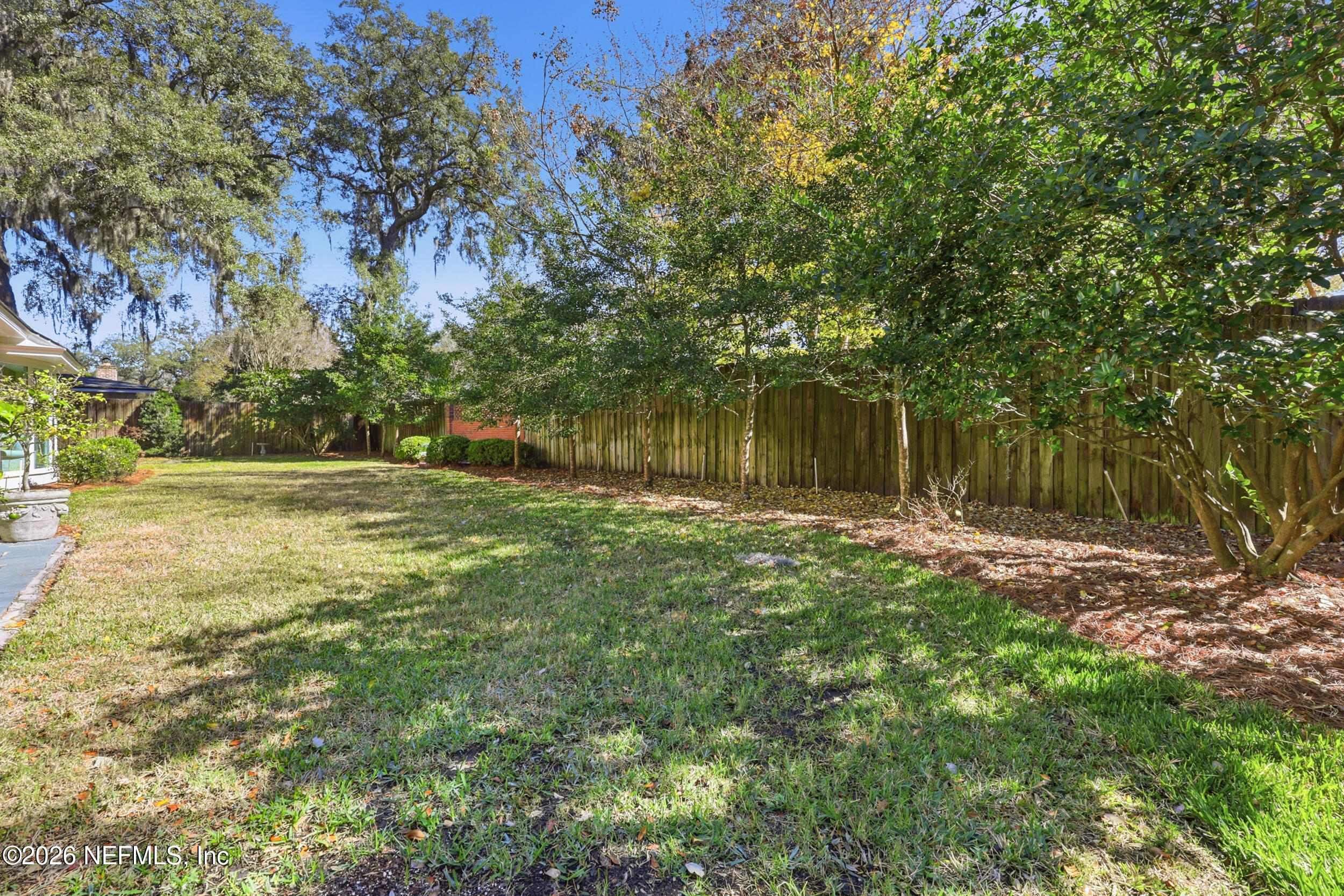 4706 Ivanhoe Road Jacksonville, FL 32210 - Photo 42 of 47 a backyard of a house with lots of green space