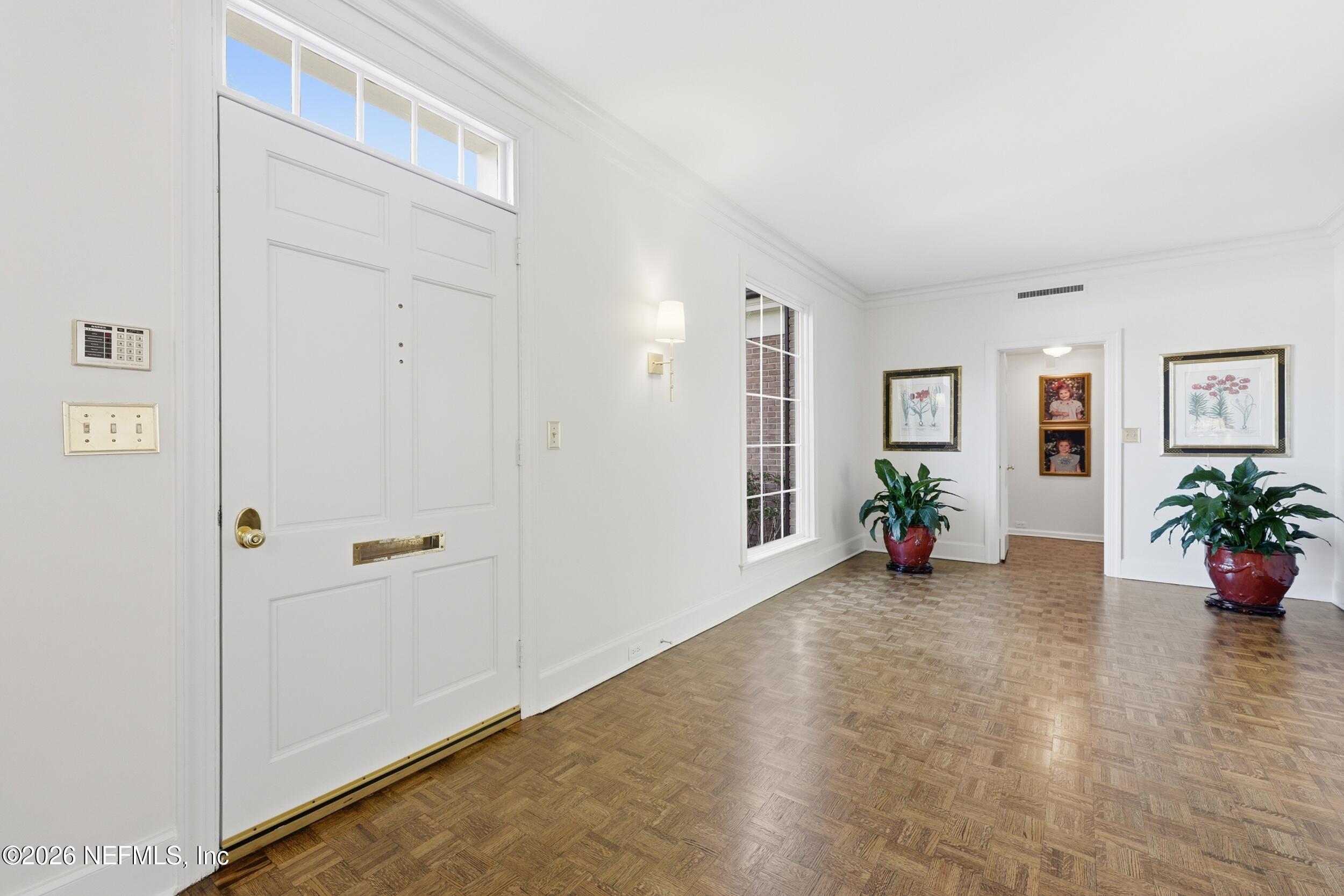 4706 Ivanhoe Road Jacksonville, FL 32210 - Photo 5 of 47 an empty room with potted plants and wooden floor