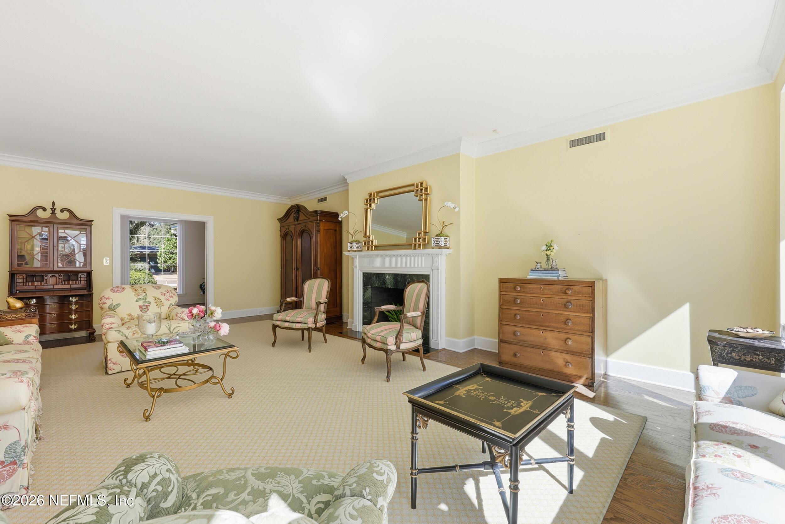 4706 Ivanhoe Road Jacksonville, FL 32210 - Photo 7 of 47 a living room with furniture and a fireplace