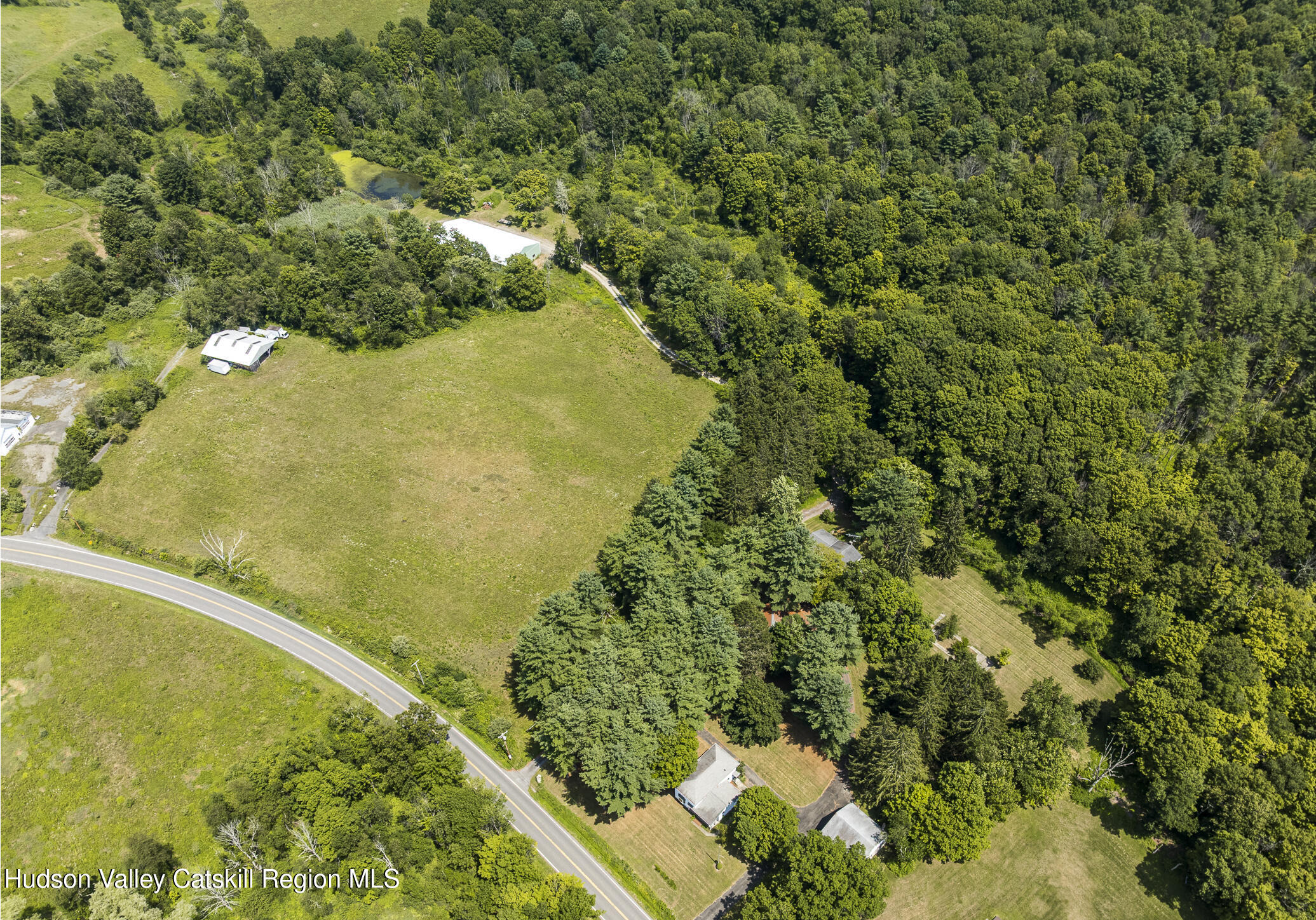 174 Co Rte 11 Pine Plains, NY 12567 - Photo 2 of 37 a view of a lake with a yard
