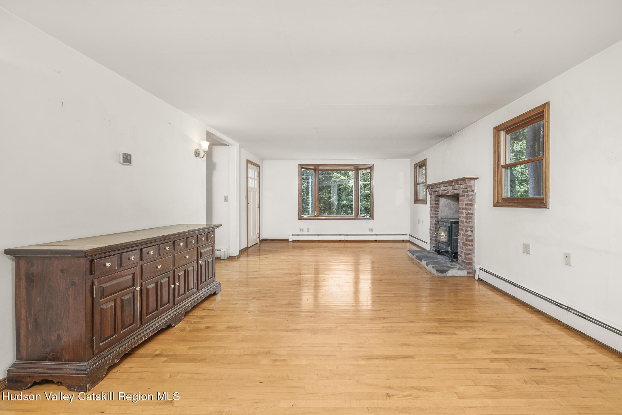 174 Co Rte 11 Pine Plains, NY 12567 - Photo 22 of 37 a view of an empty room with window and wooden floor