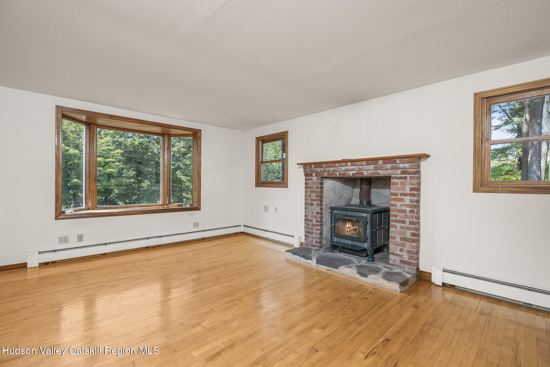 174 Co Rte 11 Pine Plains, NY 12567 - Photo 23 of 37 an empty room with windows and fireplace