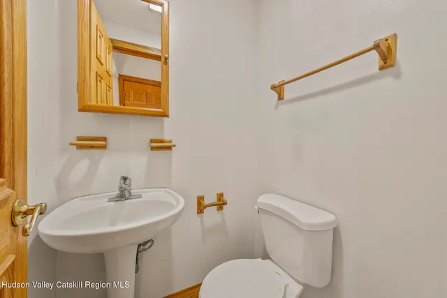 a white toilet sitting next to a window