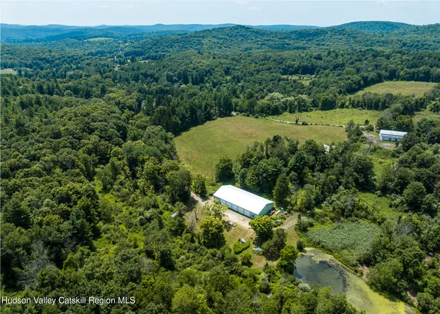 an aerial view of a house with a yard