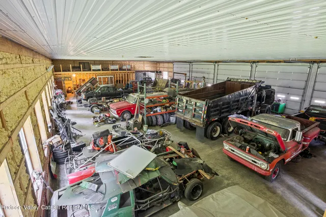 a view of a house with a yard plants and trees