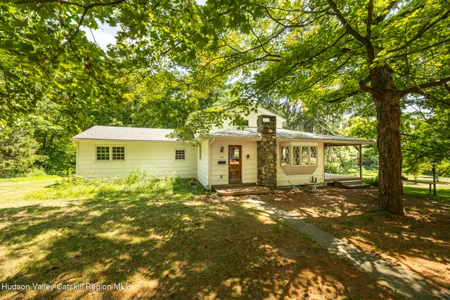 a view of a house with a tree