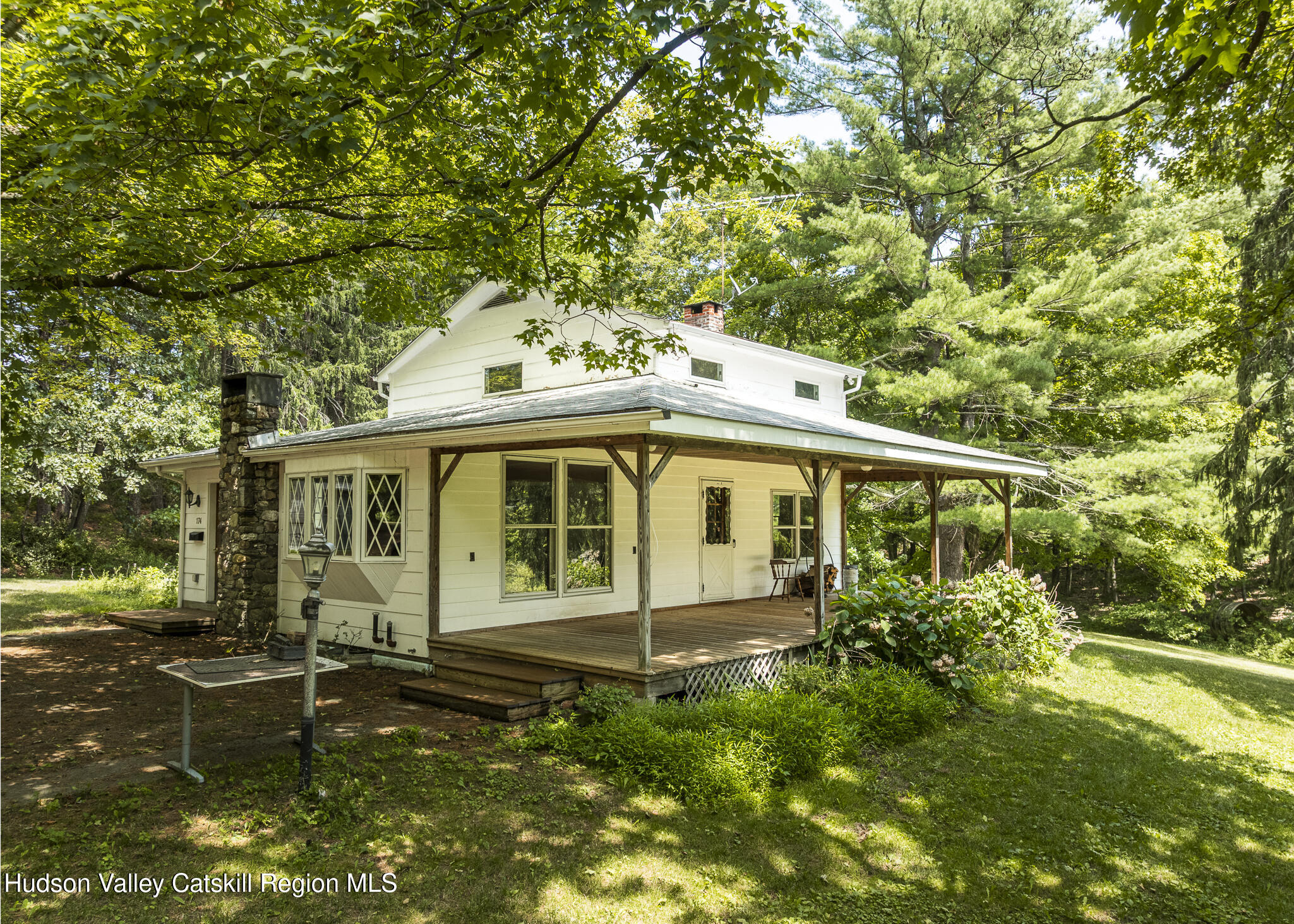 174 Co Rte 11 Pine Plains, NY 12567 - Photo 5 of 37 a view of a white house with large windows and a small yard