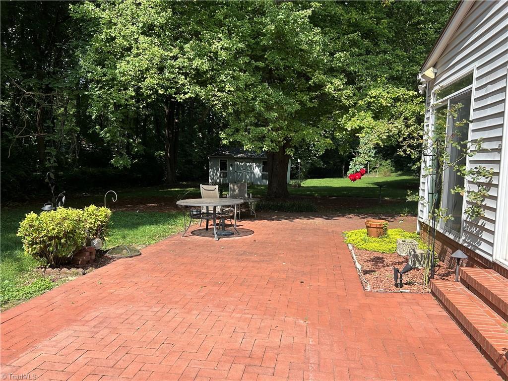 2911 Pleasant Ridge Road Summerfield, NC 27358 - Photo 11 of 47 Brick patio off sunroom
