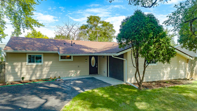 187 Queenswood Road Bolingbrook, IL 60440 - Photo 1 of 36 a front view of a house with a yard