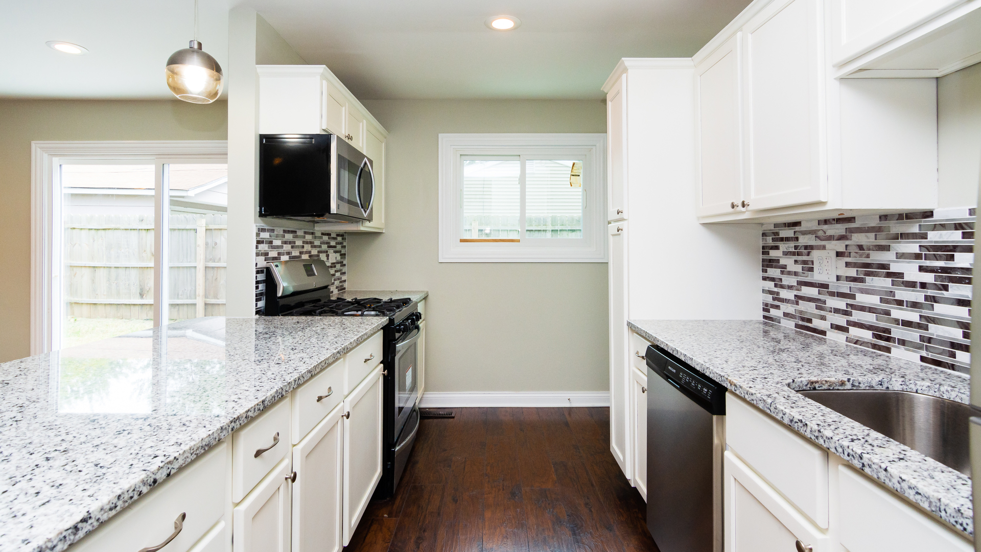 187 Queenswood Road Bolingbrook, IL 60440 - Photo 13 of 36 a kitchen with stainless steel appliances kitchen island granite countertop a sink and a stove