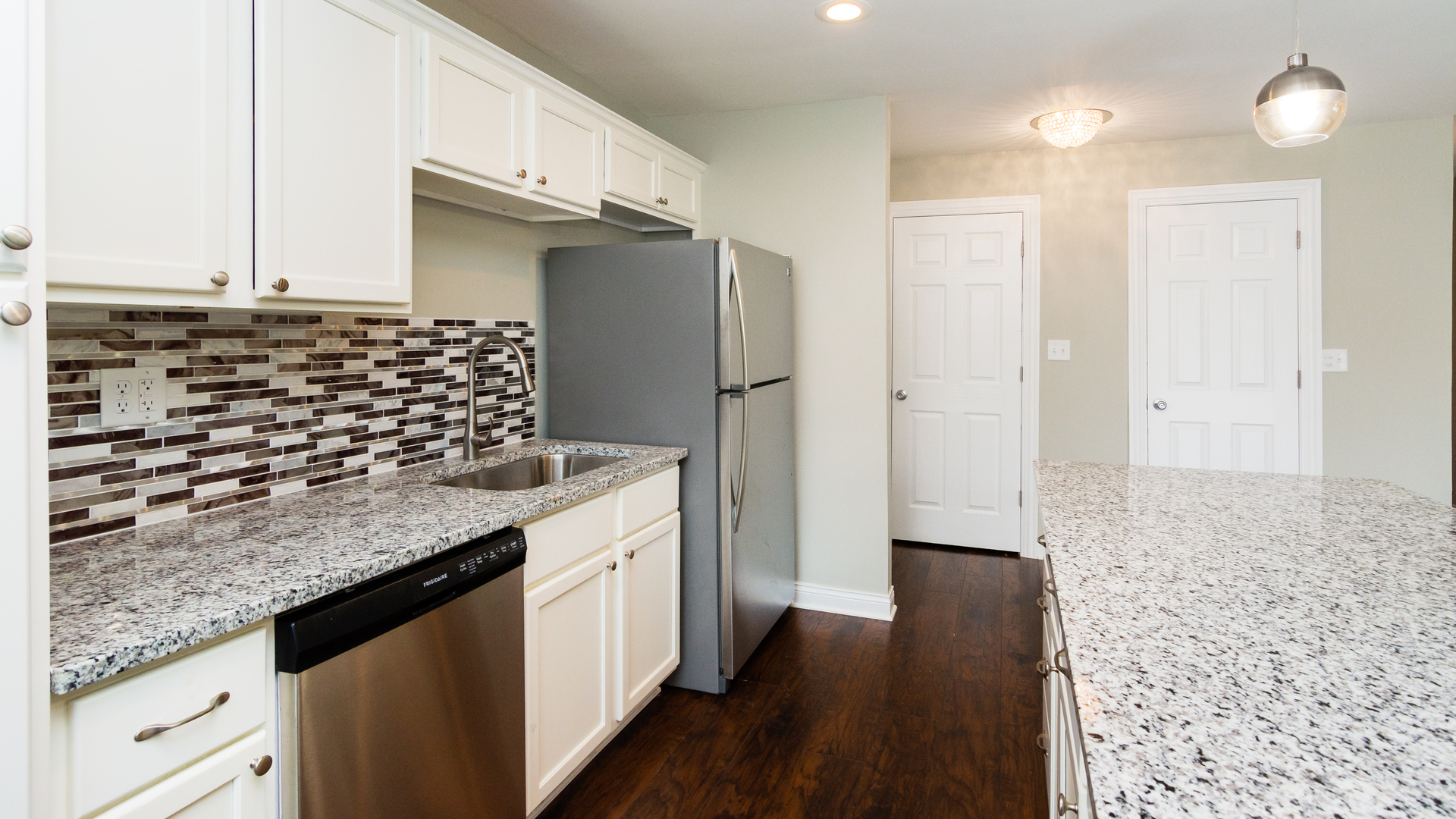 187 Queenswood Road Bolingbrook, IL 60440 - Photo 16 of 36 a kitchen with granite countertop a sink and a refrigerator