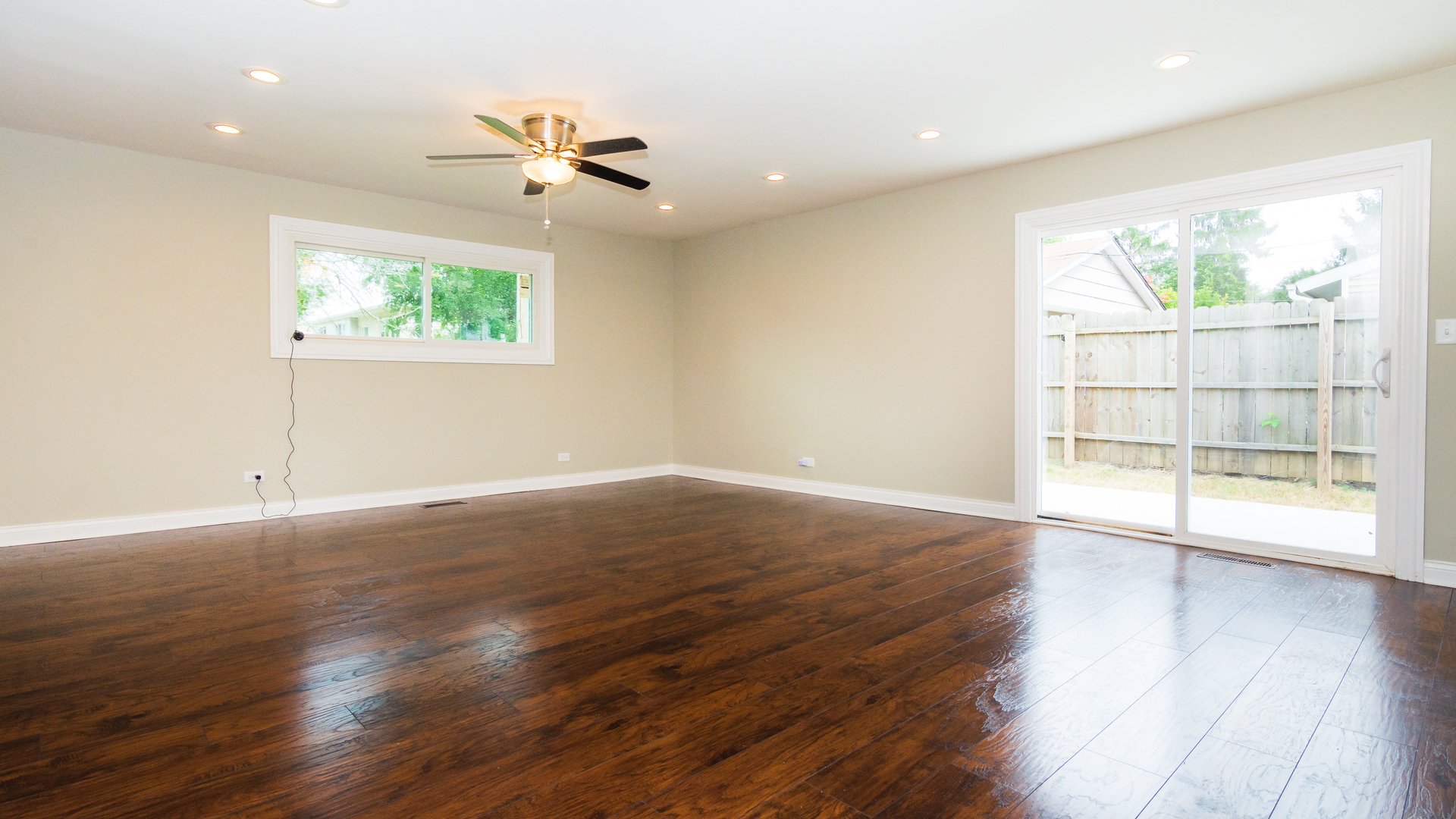 187 Queenswood Road Bolingbrook, IL 60440 - Photo 18 of 36 an empty room with wooden floor and windows