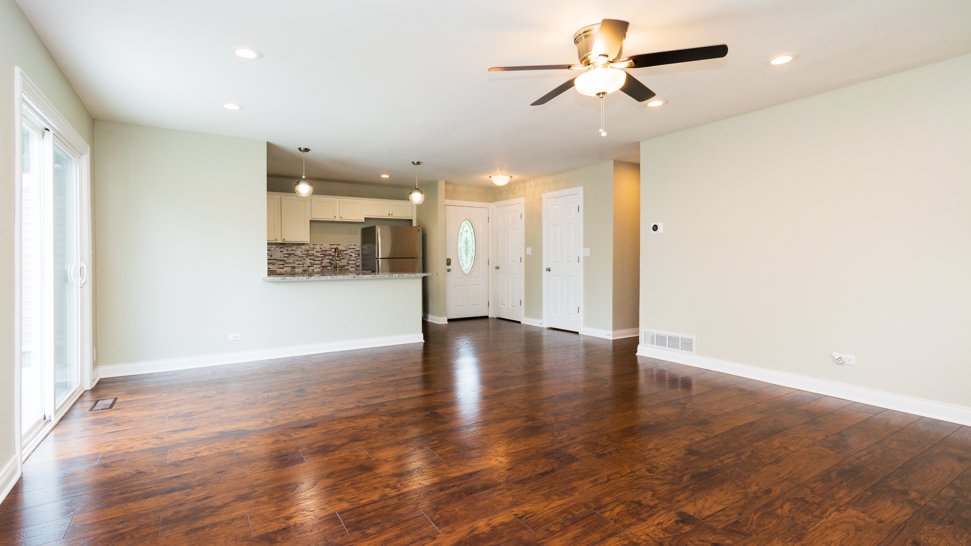 187 Queenswood Road Bolingbrook, IL 60440 - Photo 20 of 36 wooden floor in an empty room with a window