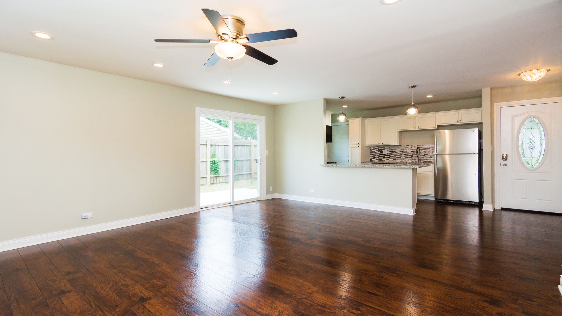 187 Queenswood Road Bolingbrook, IL 60440 - Photo 21 of 36 a view of an empty room and kitchen with wooden floor