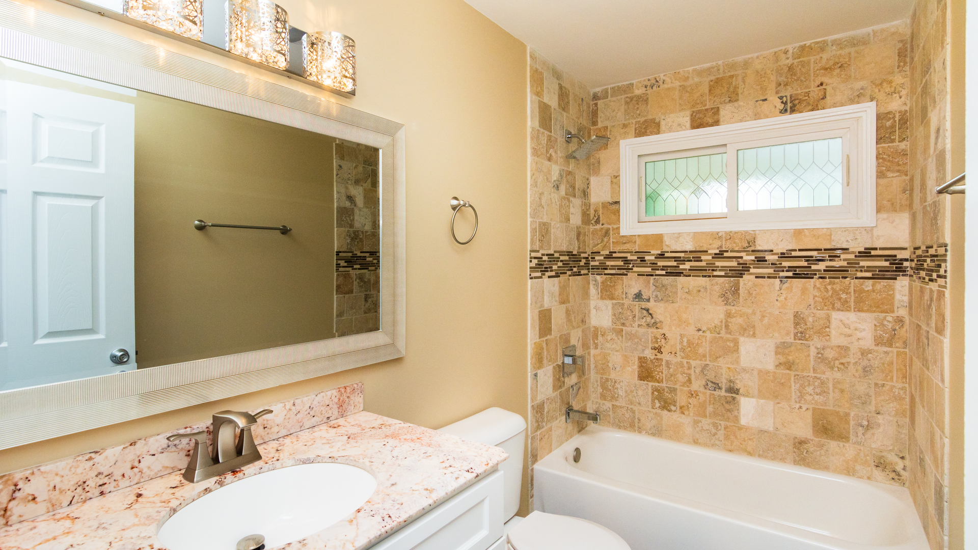187 Queenswood Road Bolingbrook, IL 60440 - Photo 24 of 36 a bathroom with a granite countertop sink a mirror a bathtub and shower