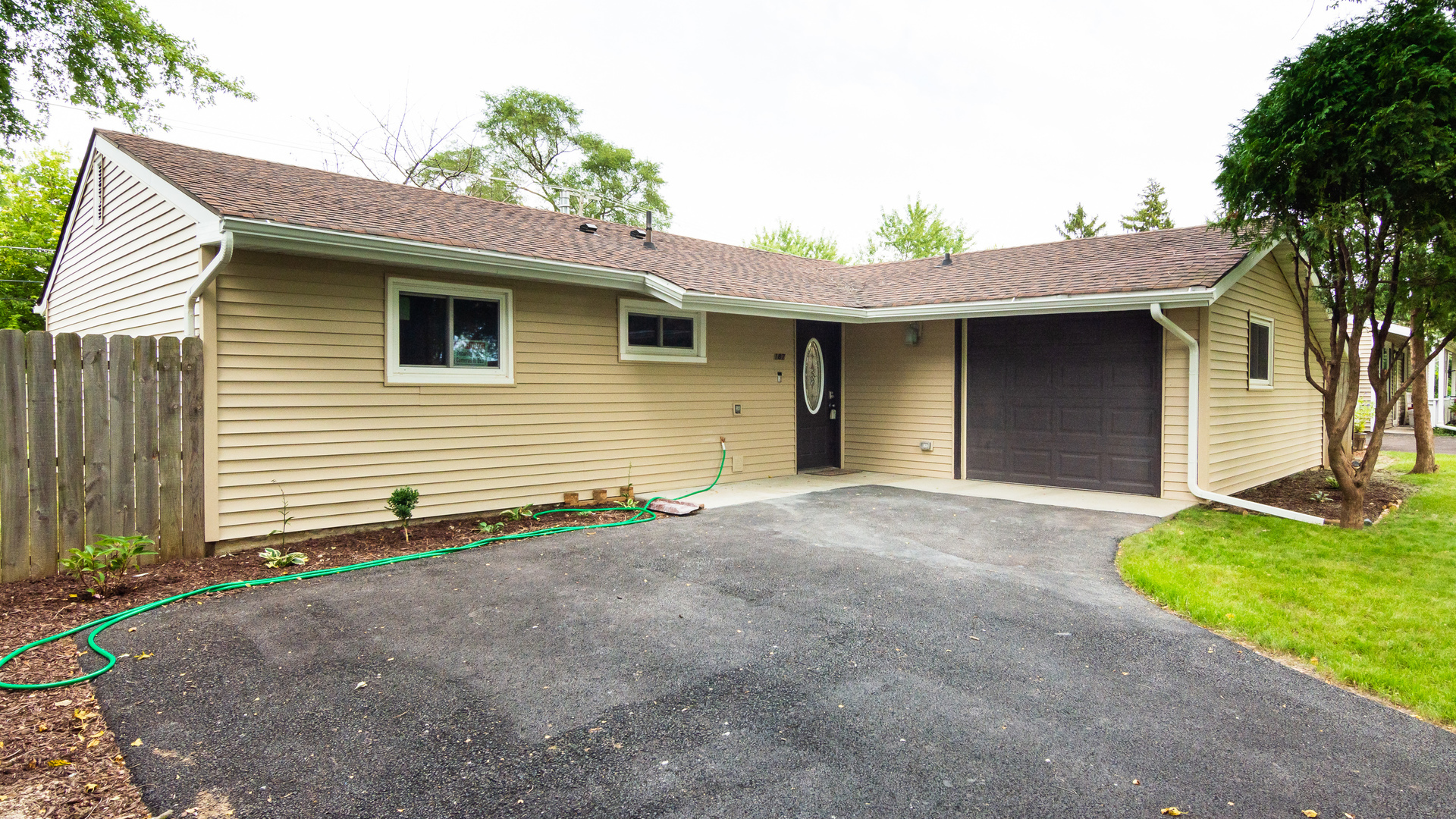 187 Queenswood Road Bolingbrook, IL 60440 - Photo 3 of 36 a front view of a house with a yard and garage