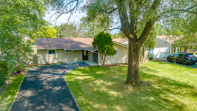 187 Queenswood Road Bolingbrook, IL 60440 - Photo 36 of 36 a view of a house with a tree in the yard