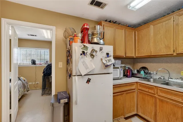 a kitchen with sink cabinets and appliances