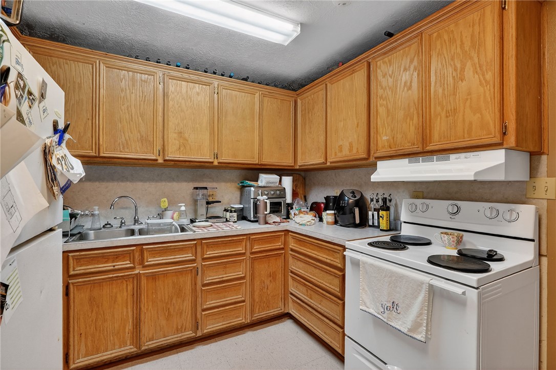 8601 Sandy Point Road Bryan, TX 77807 - Photo 19 of 50 a kitchen with sink cabinets and appliances