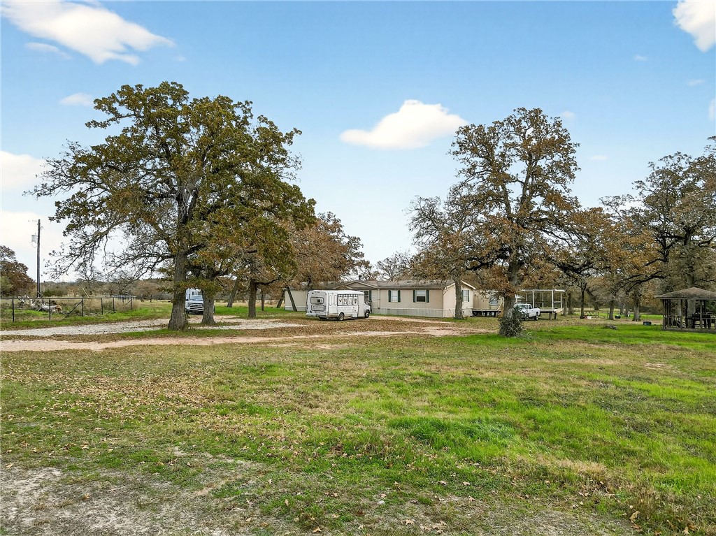 8601 Sandy Point Road Bryan, TX 77807 - Photo 22 of 50 a swimming pool is in the middle of a yard