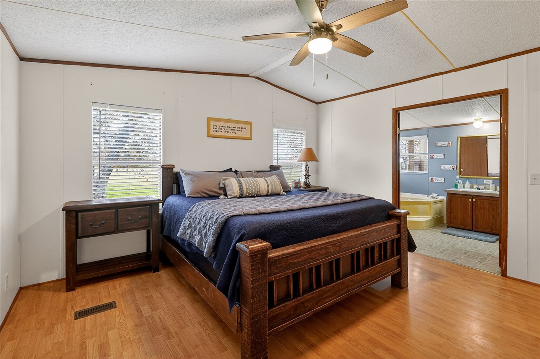 8601 Sandy Point Road Bryan, TX 77807 - Photo 27 of 50 a bedroom with a bed and a chandelier