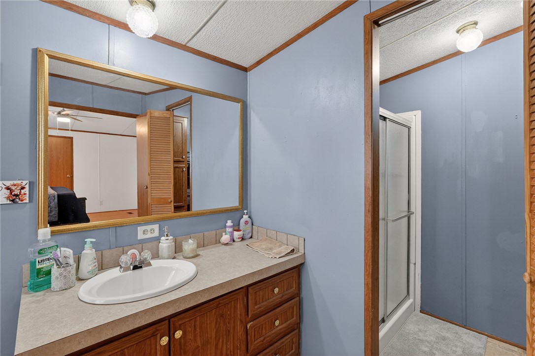 8601 Sandy Point Road Bryan, TX 77807 - Photo 29 of 50 a bathroom with a granite countertop sink and a mirror