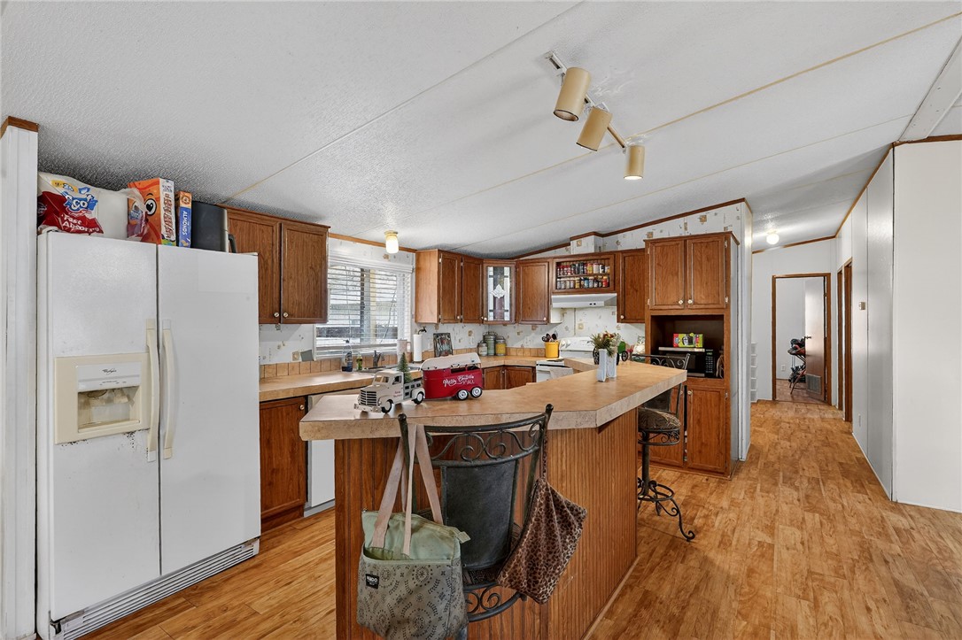 8601 Sandy Point Road Bryan, TX 77807 - Photo 31 of 50 a view of a kitchen with cabinets and wooden floor