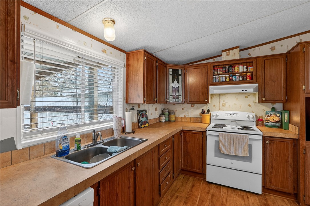 8601 Sandy Point Road Bryan, TX 77807 - Photo 32 of 50 a kitchen that has a sink and a stove