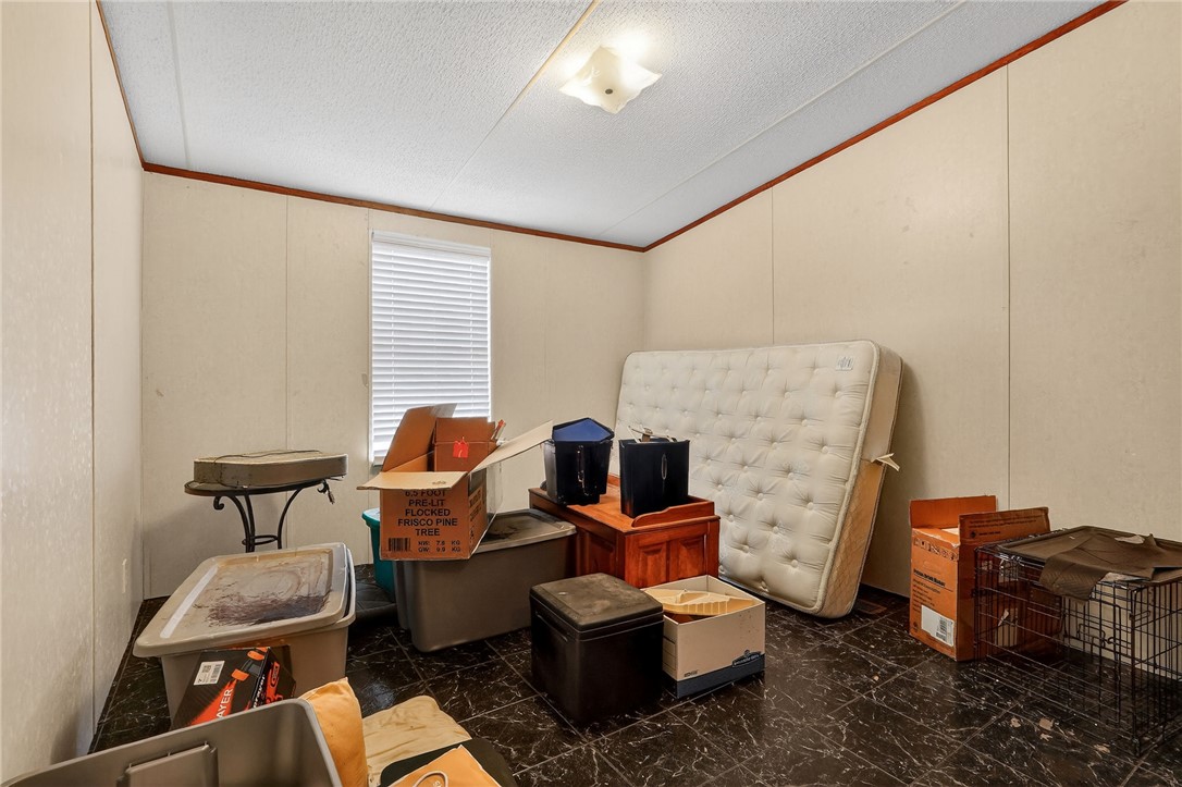 8601 Sandy Point Road Bryan, TX 77807 - Photo 34 of 50 a living room with furniture and a fireplace