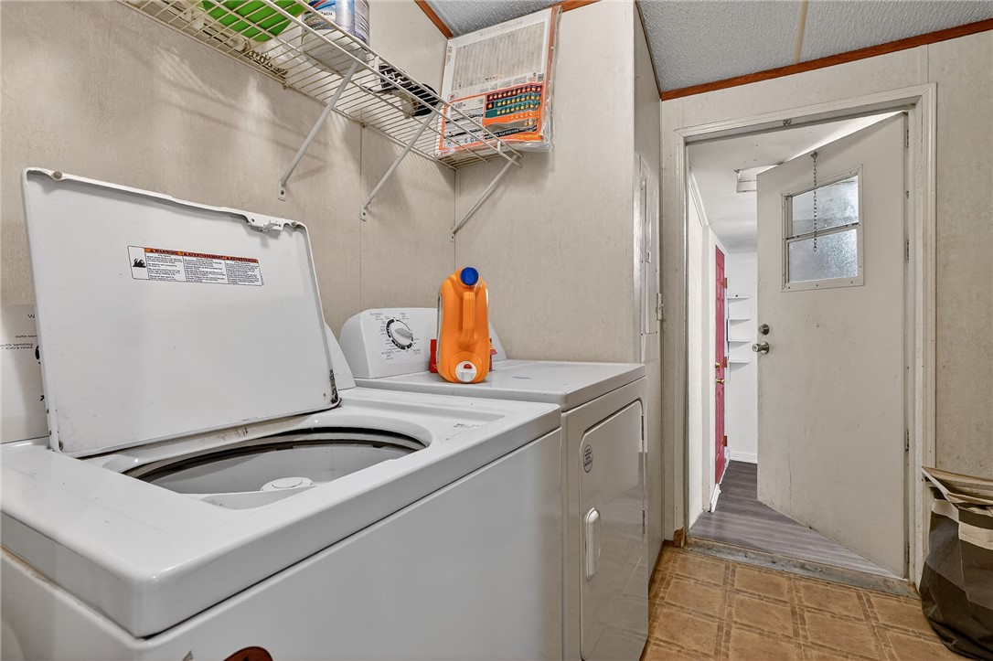 8601 Sandy Point Road Bryan, TX 77807 - Photo 39 of 50 a kitchen with a refrigerator and a stove