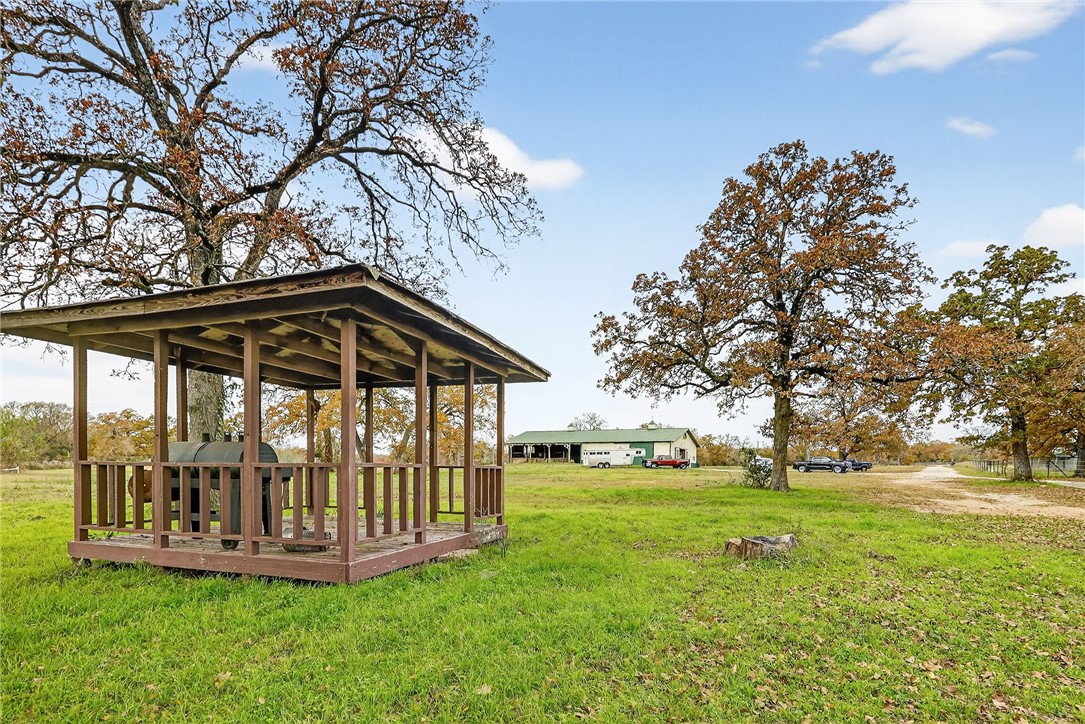 8601 Sandy Point Road Bryan, TX 77807 - Photo 7 of 50 a view of a deck with a big yard