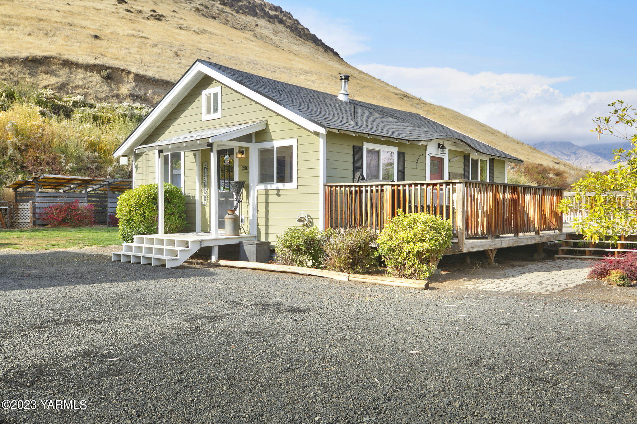 200 Ranger Road Naches, WA 98937 - Photo 1 of 23 a view of a house with a yard and potted plants