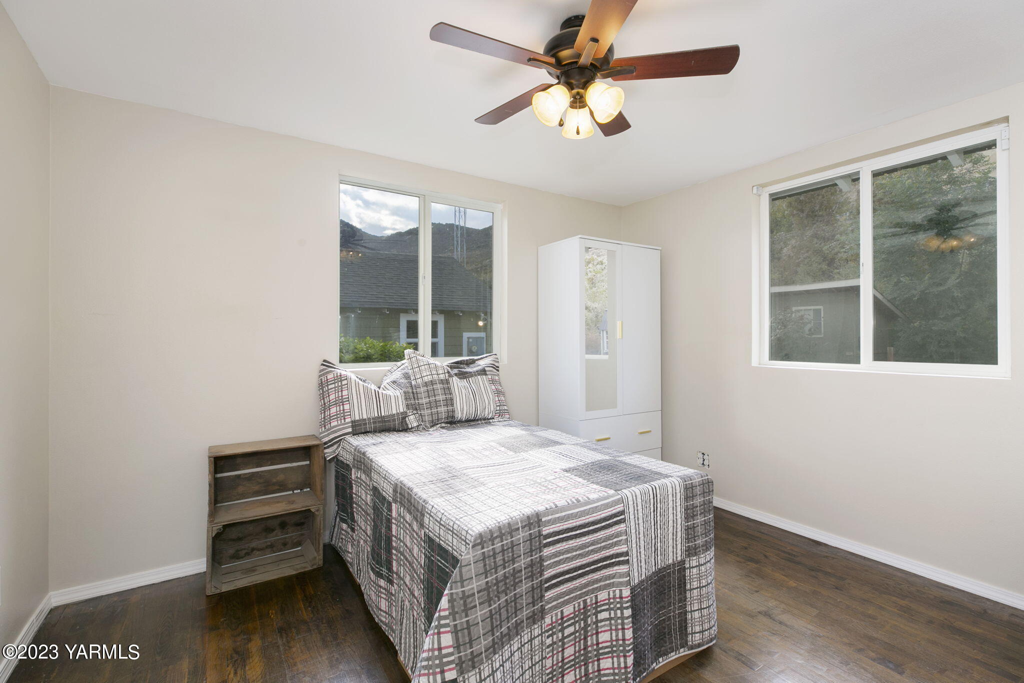 200 Ranger Road Naches, WA 98937 - Photo 12 of 23 a bedroom with a bed and a large window with wooden floor