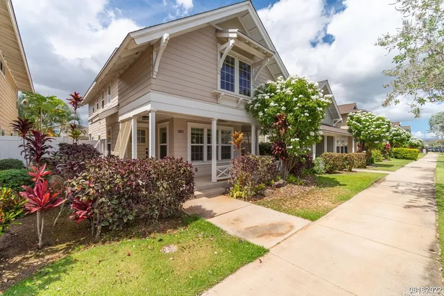 a front view of a house with a garden