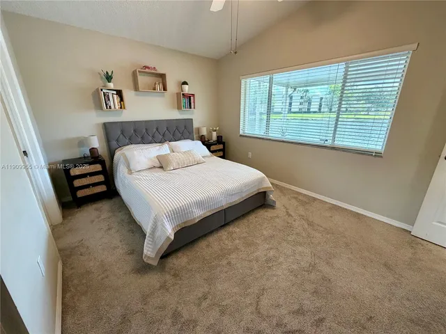 a bed sitting in a bedroom next to a window