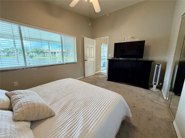 a bedroom with a bed and a television