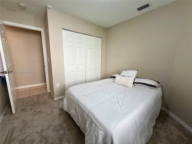 a bedroom with a bed and a rug