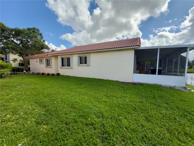 a front view of a house with a garden and yard