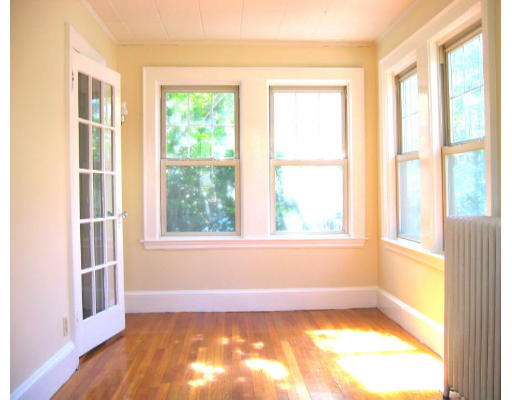 27 Fuller Road, Unit 27 LOWER Watertown, MA 02472 - Photo 1 of 1 a view of an empty room with a window and wooden floor
