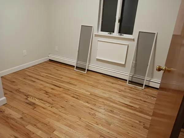 an empty room with wooden floor