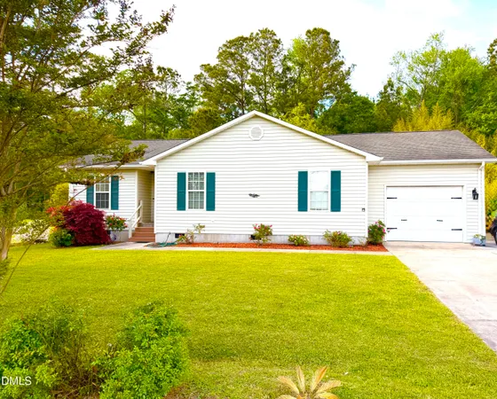 a view of a house with a yard and potted plants