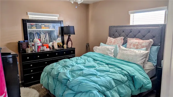 a bedroom with a bed and window