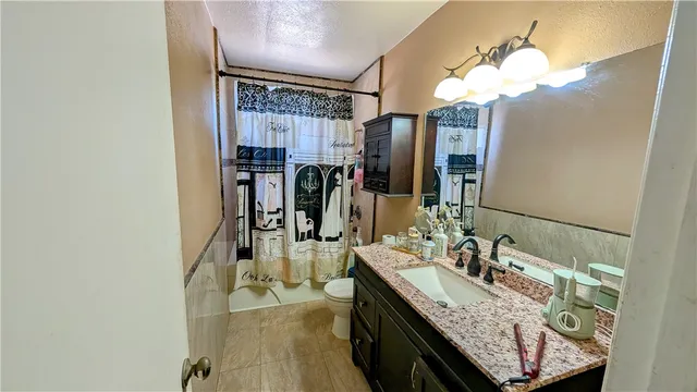 a bathroom with a sink vanity granite and a mirror