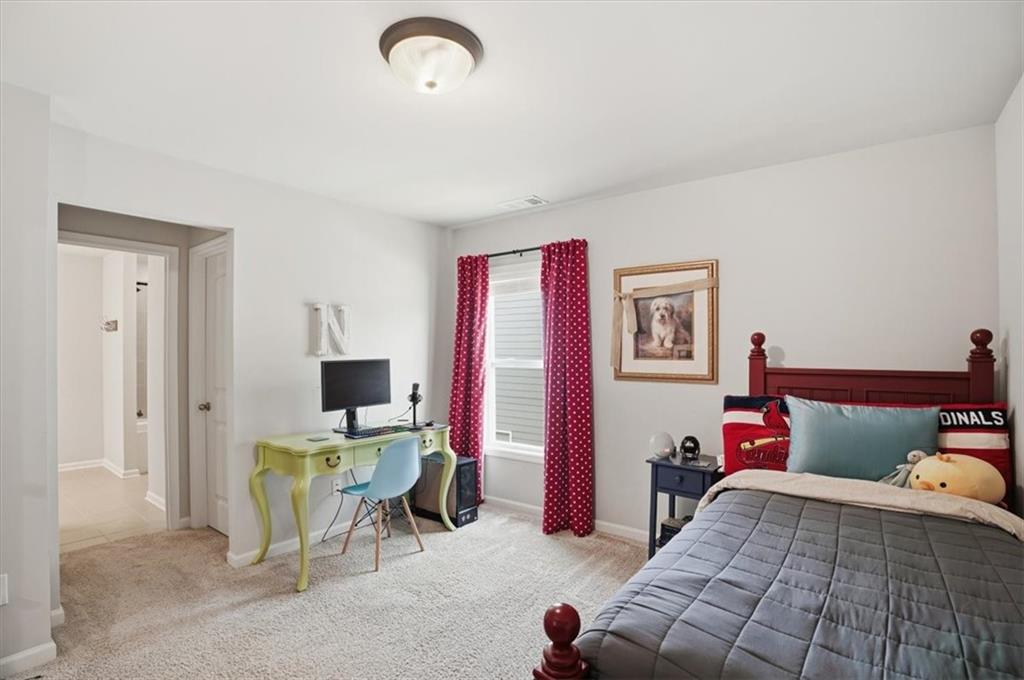 6265 Privet Way Cumming, GA 30028 - Photo 23 of 47 a bedroom with a bed and a desk